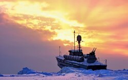 Ship In Snow At Sunset Wallpaper